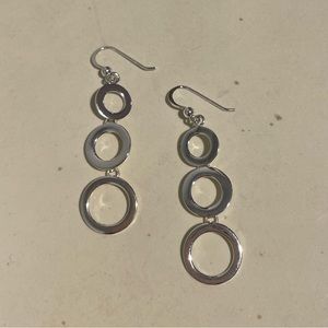 Silver earrings, dangling circles, one size.